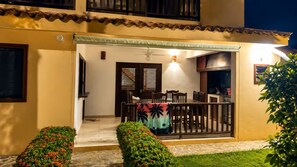 A building with a covered outdoor seating area, a door, and a window with blinds. - Tremendous 3-bedroom plus one bed loft condo with AC in Las Terrenas (Las Terrenas)