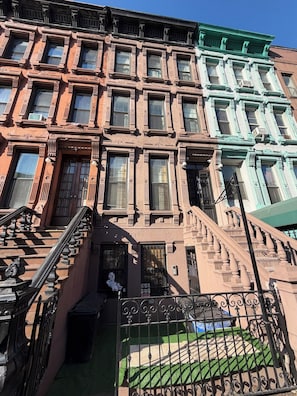 A multi-story building with a fire escape and a gated entrance. - Lexington studio (New York)