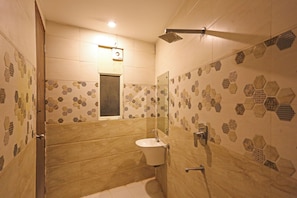 A bathroom with a toilet, sink, and shower. - Hotel Almora Near Delhi Airport  (New Delhi)