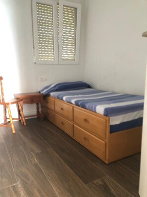 A bedroom with a bed, wooden dresser, and a desk. - New Listing (Cabo de Palos)