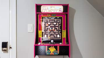 A Pac-Man arcade game machine mounted on a wall.
