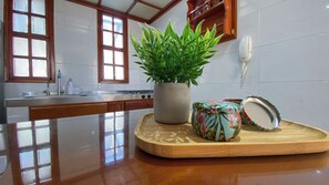 A kitchen with a wooden countertop, a potted plant, and a decorative item. - New Listing (El Rodadero)