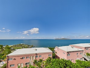 A coastal view with buildings, a clear sky, and the ocean. - Sea View Bliss Remodeled 2BR Coakley Bay Condo with Buck Island Views and AC (Christiansted)
