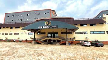 A building with a sign reading 'Soul Lounge Resorts' and a paved area in front.