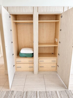 A wooden wardrobe with two drawers and a shelf, a mattress on the shelf, and a light-colored floor. - 24th Floor 1-bedroom Full Kitchen Washer/Dryer Sunny Isles Direct Beach Access (Sunny Isles Beach)
