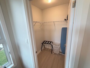 A laundry area with a drying rack, a blue cabinet, and a window with a view of the outdoors. - Scenic Kitchener Retreat | Escarpment View Balcony (Kitchener)