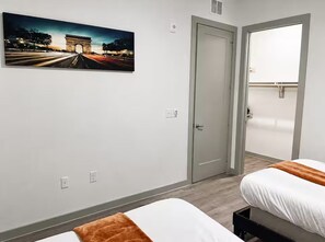 A hotel room with two beds, a large window, and a door leading to a balcony. - Chic & Homey Apartment 2BR/1BA Austin TX (Austin)