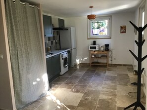 A compact kitchen with a washing machine, a microwave, and a small window. - New Listing (Romans-sur-Isère)