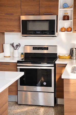 A kitchen with a stainless steel microwave, oven, and toaster. - NEW! Casa Coquito Rooftop + 5 min to Surf City (san blas)