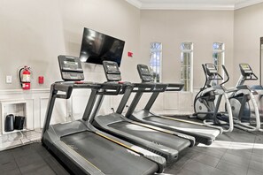 A gym with treadmills, a television, and fire extinguishers. - Upscale Vista Cay 3BR With Resort Pool View (Orlando)