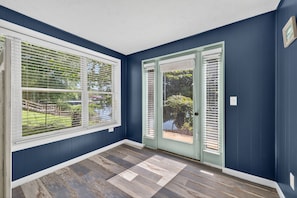 A room with dark blue walls, a wooden floor, and two doors with glass panels. - Lake House on Boone Lake (Kingsport)