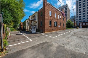 A parking lot with a brick building, a staircase, and a clear sky. - 1.2 Miles to NIH & Walter Reed - Walk to Metro (Bethesda)
