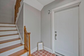 A staircase with wooden handrails and a white door with a number '2' above it. - 1.2 Miles to NIH & Walter Reed - Walk to Metro (Bethesda)