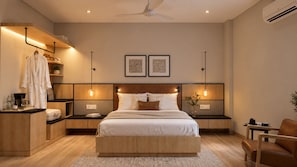 A modern bedroom with a large bed, bedside tables, a wardrobe, and a ceiling fan. - Bless Ganga by Solvaya Rishikesh (Rishikesh)