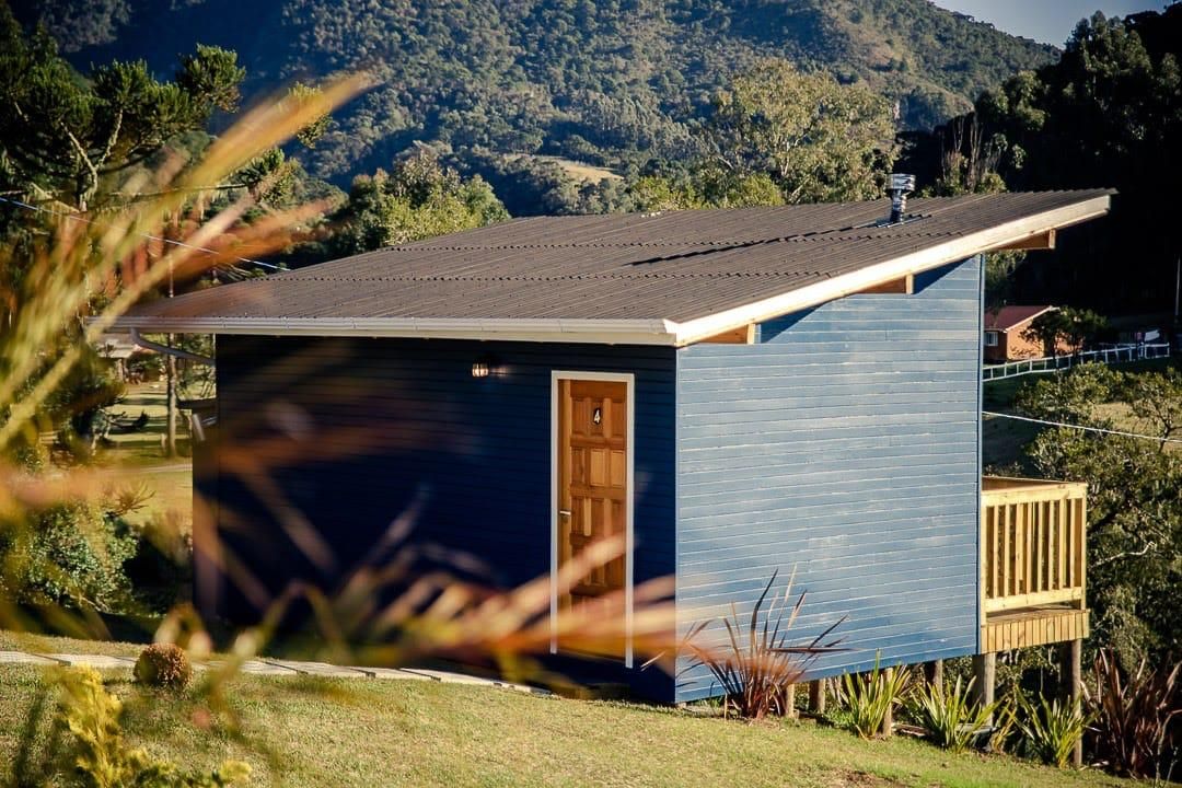 A small, single-story building with a dark blue exterior and a sloped roof.