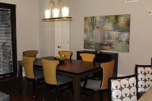 A dining area with a dark wooden table, four chairs with patterned upholstery, a chandelier, and a painting on the wall. - CANYON VILLAGE/CLUB WYNDHAM PARK CITY, 3BR, FEB 6-9,2027, GREATEST SNOW ON EARTH (Park City)