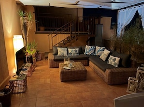 A cozy living area with a sofa set, wicker side tables, and potted plants. - New Listing (Palermo)
