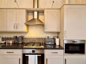 A modern kitchen with stainless steel appliances, including a stove, oven, and toaster. - Spacious, Spacious & Modern Apt w/ Free Parking (Coventry)
