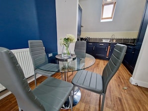 A modern kitchen with dark cabinets, a white countertop, and a window above the sink. - Spacious, Chic & Modern Apt w/ Free Parking (Coventry)