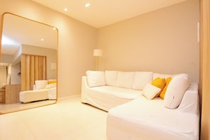 A modern hotel room with a large mirror, a white sofa, and a lamp. - New Listing (Rio de Janeiro)