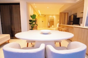 A modern dining area with a round table, two chairs, and a plant. - New Listing (Rio de Janeiro)