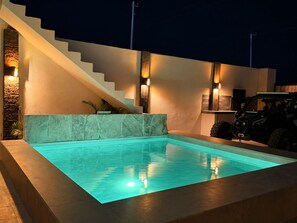 A swimming pool with a stone wall and a staircase. - New Listing (El Centenario)