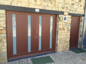 A stone building with two large wooden doors, each marked with a number.