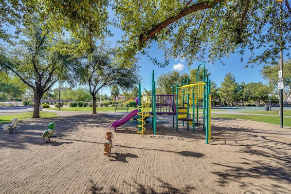 A playground with a slide, swings, and climbing structures. - Soothing 3-bedroom house with AC in charming Peoria (Peoria)
