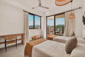 A hotel room with two beds, a desk, and a chair. - Mar Azul at La Esquina: San Pancho 2BR Sleeps 6, 1 Block to Beach (San Pancho)