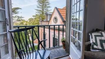 Charming balcony with leafy views and storybook architecture