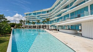 A modern hotel with a large pool, multiple balconies, and a well-maintained garden. - New Listing (Bucerías)