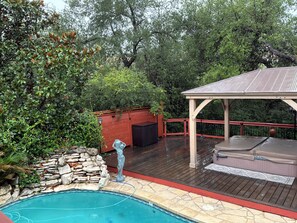 A swimming pool with a stone border, a wooden deck, a gazebo, and a hot tub. - 3-2.5 house in gated Westlake Hills w/pool, heated spa, fenced yard & EV charger (Austin)
