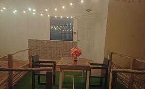 A small room with a table and chairs, a window, and a door. - New Listing (Temax)