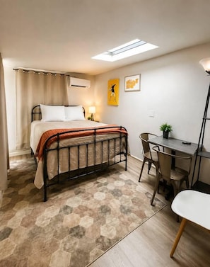 A bedroom with a bed, a desk, a chair, and a small table with a plant. - 2 Studios + 2BR Home Near Whiskey Row (Prescott)
