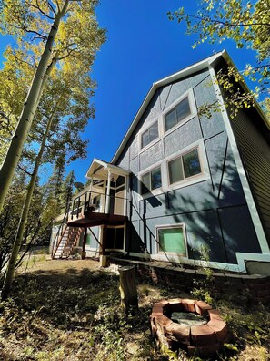 A two-story house with a covered porch and a fire pit in the yard. - Whole Black Hawk Home w/ Game Room and Home Gym Near Casinos and Hiking! (Black Hawk)