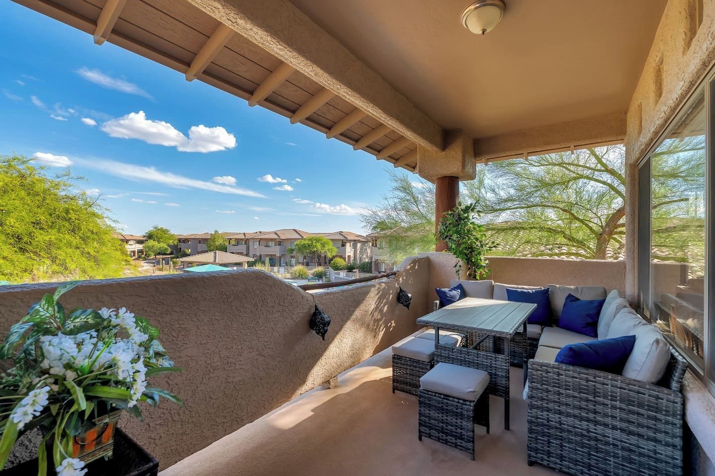 Private balcony with direct pool view, gorgeous mountain views, and comfortable outdoor dining/seating