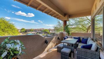 Private balcony with direct pool view, gorgeous mountain views, and comfortable outdoor dining/seating