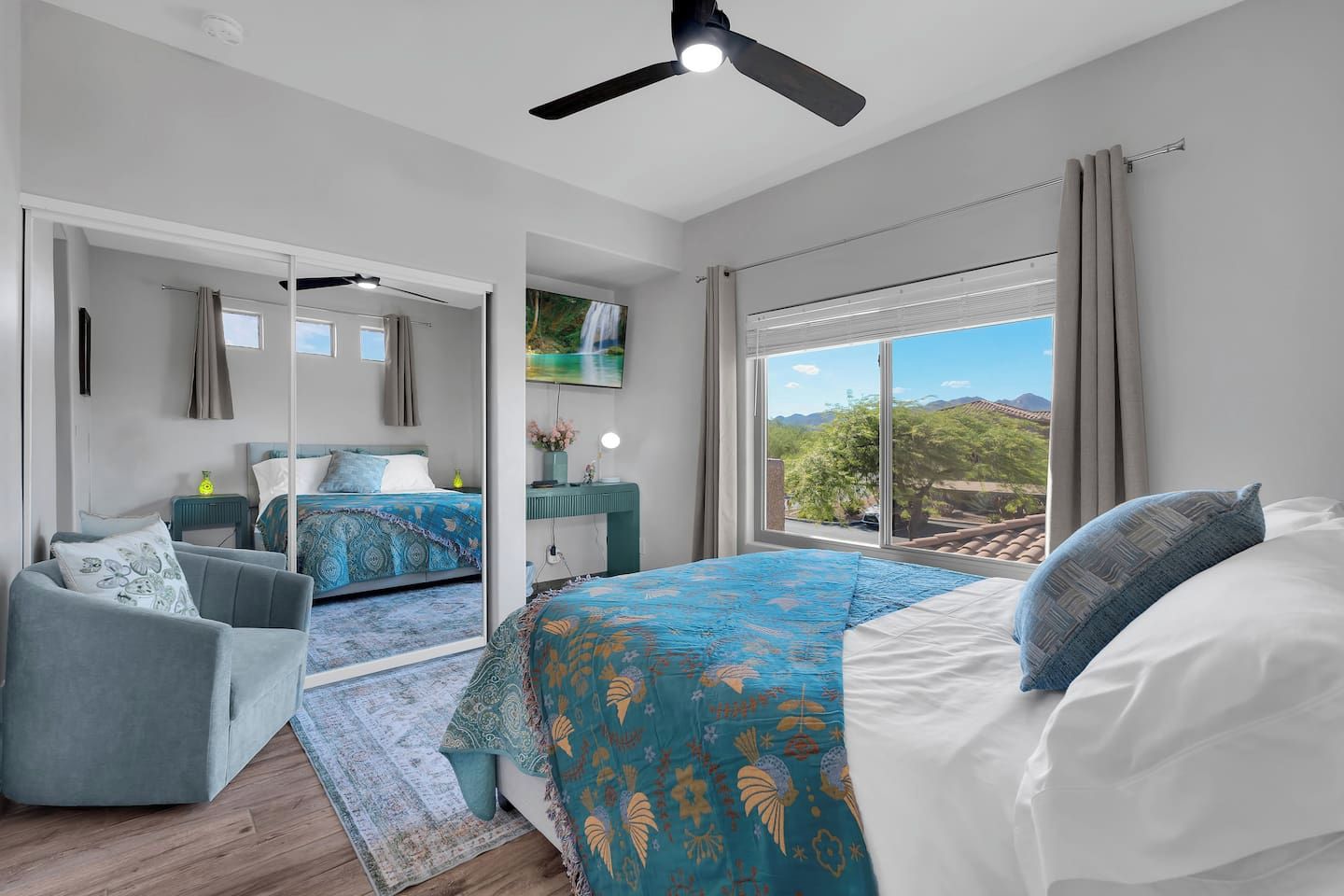 Luxurious queen bedroom with stunning mountain views, smart-TV, and work desk.