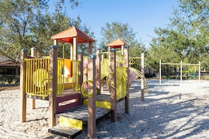 A playground with a slide and climbing structures. - BRAND NEW | Solterra Home, Pool + Spa & Game Room 5184 (Davenport)