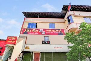A building with a sign for 'Vira Palace' indicating it is a lodging and boarding establishment.