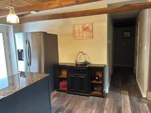 A kitchen with a granite countertop, stainless steel appliances, and a wooden ceiling. - Private Modern Lodge 2-bedroom apartment in peaceful Saint Leonard (Saint Leonard)