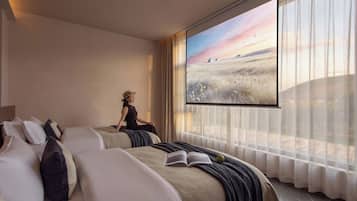 A hotel room with a large window, a bed, a chair, and a book.