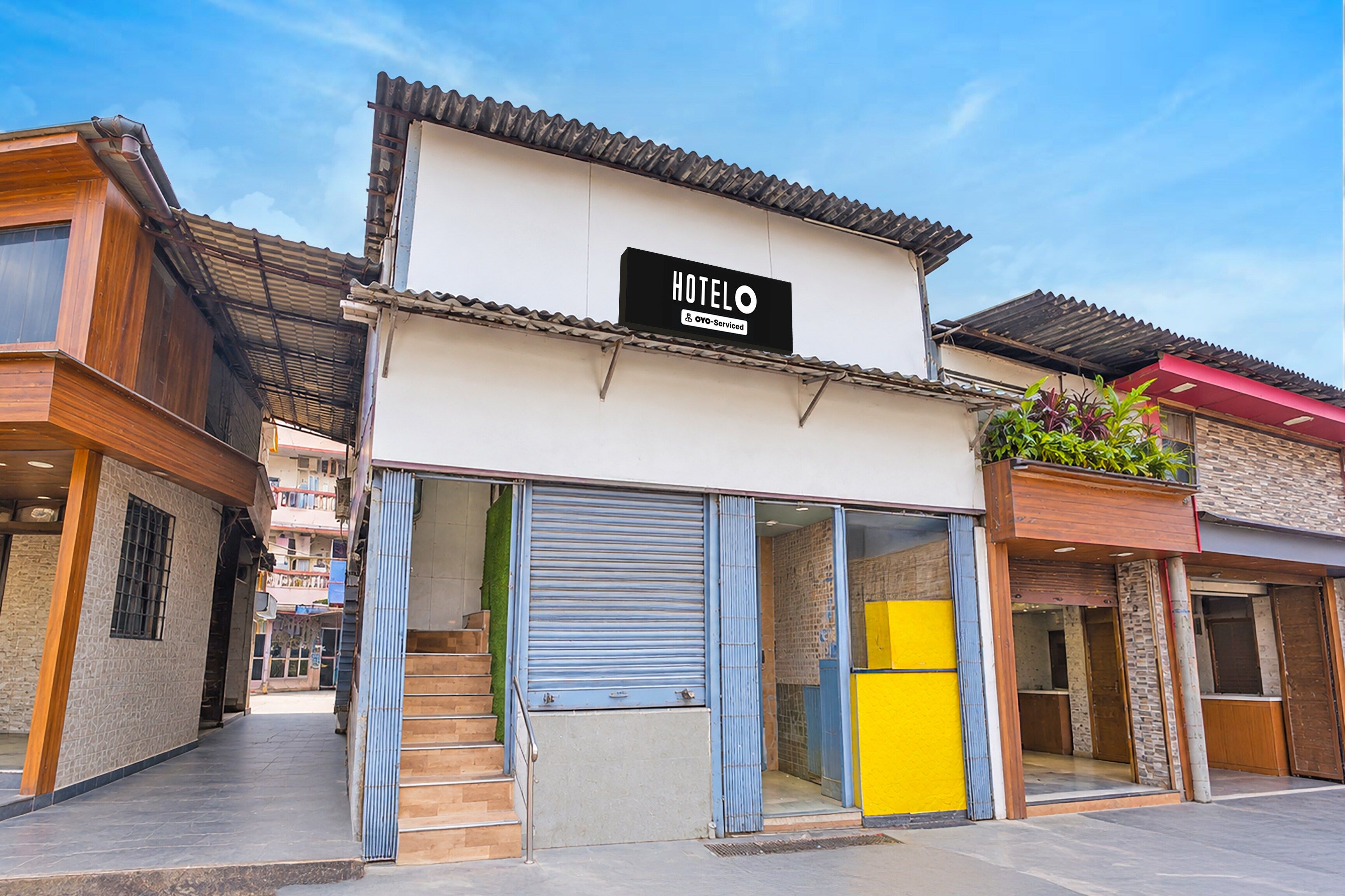 A hotel with a sign indicating it is serviced by OYO.