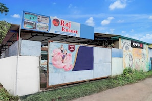 A building with a sign for Raj Resort, featuring amenities like a swimming pool, birthday bash, and a birthday bash available. - Hotel O Raj Resort (Vasai)