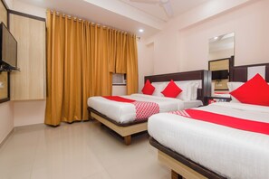 A hotel room with two beds, a large mirror, a wardrobe, and a curtain. - Hotel O Gems (Mumbai)