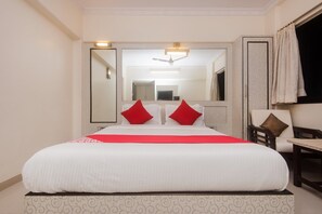 A hotel room with a large bed, a television, a desk, and a chair. - Hotel O Solitaire (Mumbai)