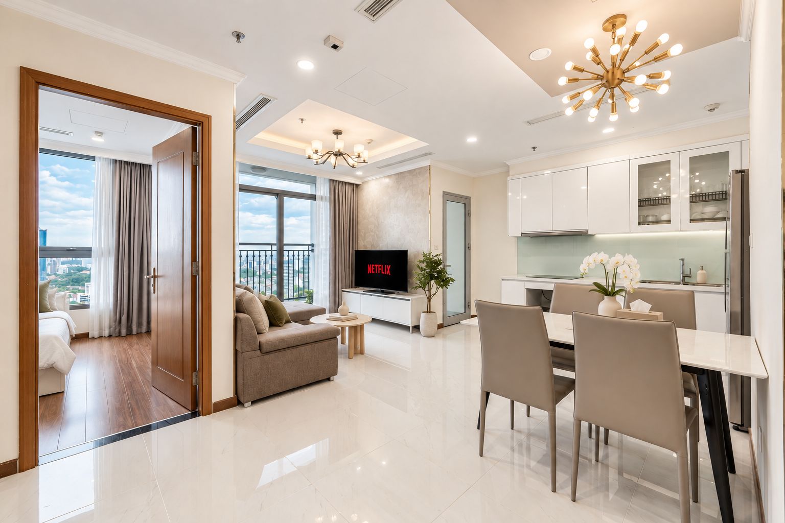 A modern living room with a sofa, TV, and dining area.
