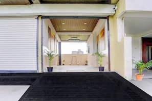 A building entrance with a ramp leading to a covered area.