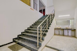 A staircase with metal railings leading to an upper floor.