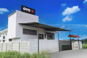 A building with a sign reading 'OYO AP Lodge' and a gated entrance.
